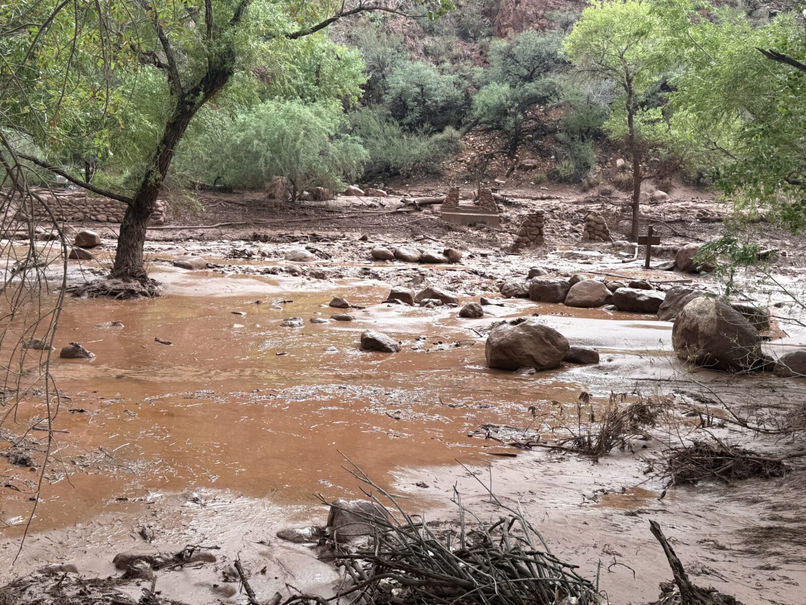Muddy Bright Angel Creek and broken bridge pylons after the August 29 2026 flood