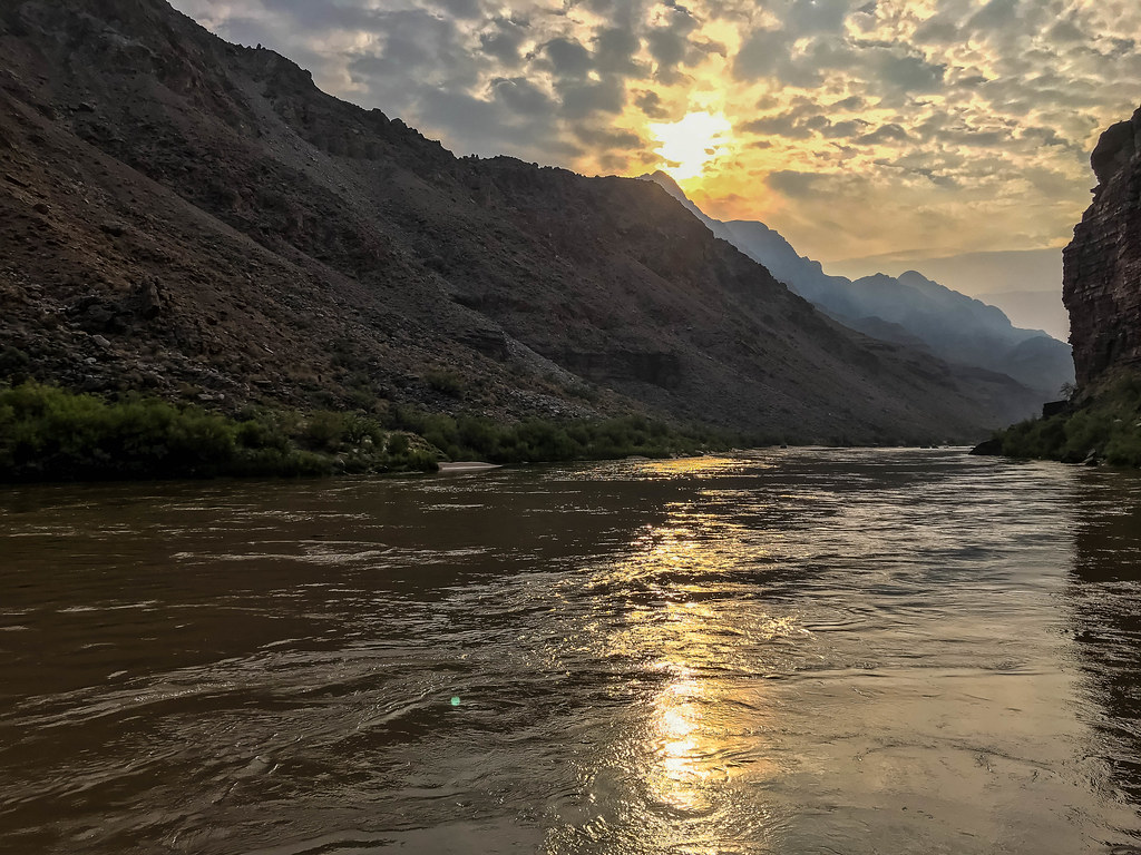 Golden sunrise reflected on the Colorado River in Grand Canyon